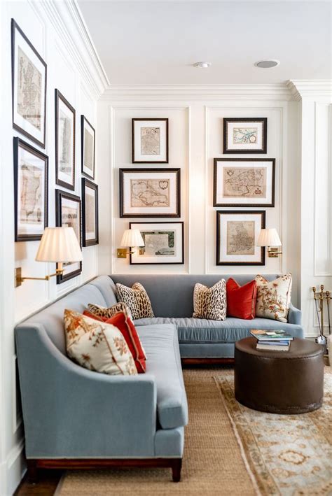 A Living Room Filled With Lots Of Furniture And Framed Pictures On The