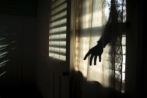 Premium AI Image | Scary shadow of a hand holding a knife reflected on a frosted window