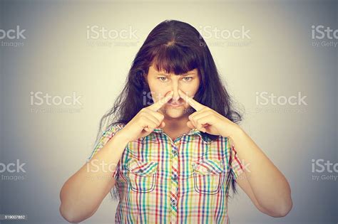 Young Woman Holding Her Nose Because Of Bad Smell Stock Photo