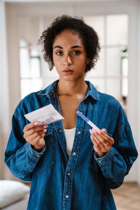 Young Black Woman Being Upset While Lying With Pregnancy Test In Bed