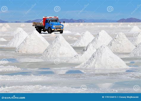 Piles Of Drying Salt And Reflection In The Water At The Salar De Uyuni