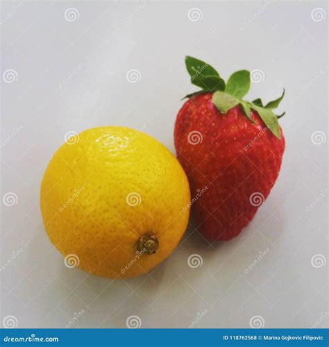 The Same Size Small Lemon And Big Strawberry On Neutral Background