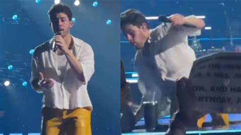 Watch Nick Jonas Falls On Stage During Boston Concert Screams Ouch