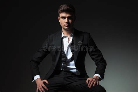 Dominant Man In Tuxedo With Open Collar And Undone Bowtie Stock Photo