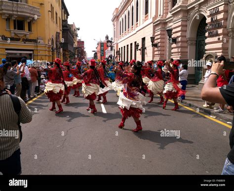 People In Traditional Peruvian Dress Dancing In The Street In Lima