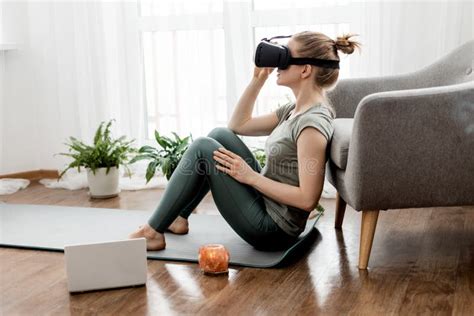 Vr Yoga A Young Woman Sits In A Lotus Position In A Virtual Reality