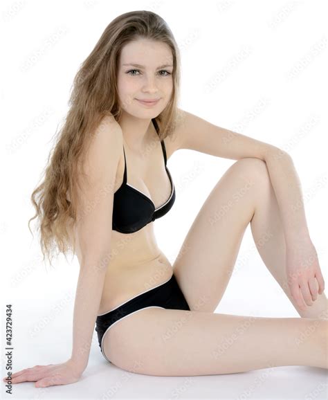 Gorgeous Teenage Girl Wearing A Black Bikini In Studio Isolated On