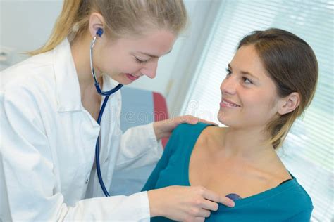 Doctor Female Listening To Patient Heartbeat With Stethoscope Stock