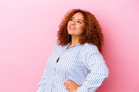 Jovem latina curvilínea isolada na parede rosa relaxada e feliz rindo pescoço esticado