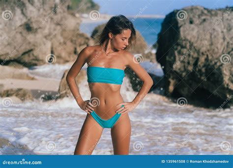 Beautiful Woman In Blue Bikini Posing And Tanned On Summer Vacation At