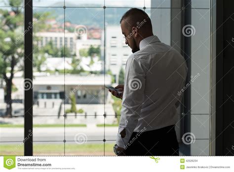 Business Man Texting On Cellphone In Modern Office Stock Photo Image