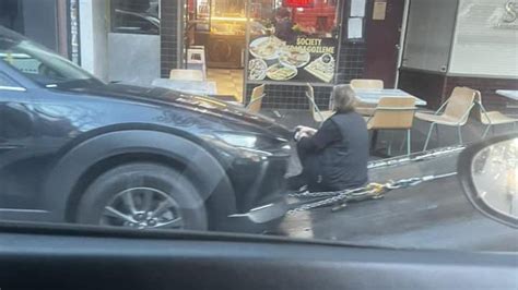 Driver Sits In Front Of Their Car For Hours To Prevent It From Being