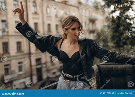 Stylish Fashionable Blonde Woman With Smoky Eye Make Up In Jeans