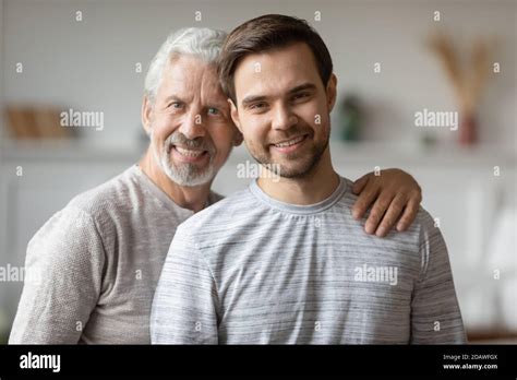 Head Shot Portrait Smiling Mature Father And Adult Son Hugging Stock Photo Alamy
