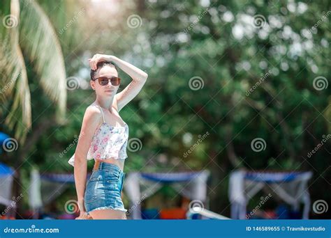 Beautiful Young Girl Relaxing Near The Swimming Pool Stock Image