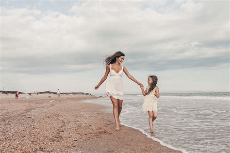 Premium Photo Happy Mother And Daughter Enjoying Sunny Day On The Beach