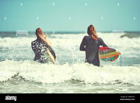 Couples Who Surf Together Stay Together A Young Couple Surfing At The