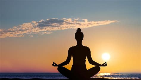 Premium Photo | Woman meditates practices yoga on the top of the mountain