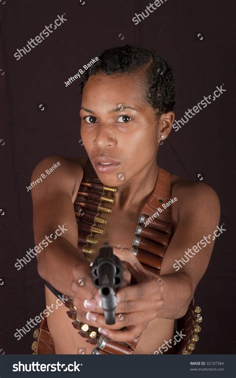 Beautiful African American Woman Isolated On Black Pointing Gun At