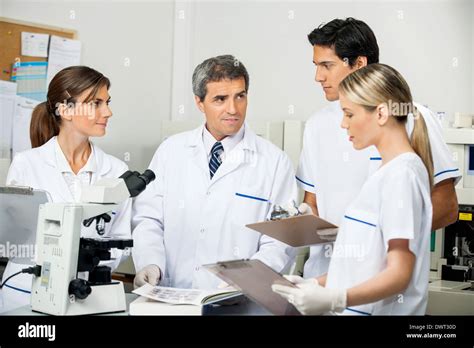 Scientist With Students Taking Notes In Laboratory Stock Photo Alamy