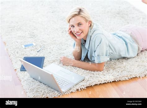 Pretty Blonde Woman Lying On The Floor And Using Her Laptop Stock Photo Alamy