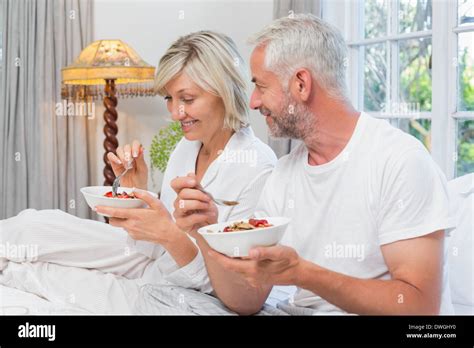 Mature Couple Having Breakfast In Bed Stock Photo Alamy