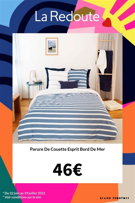 A Bed Room With A Neatly Made Bed Next To A Colorful Wallpaper And Poster