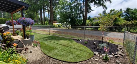 a yard with grass and flowers in it