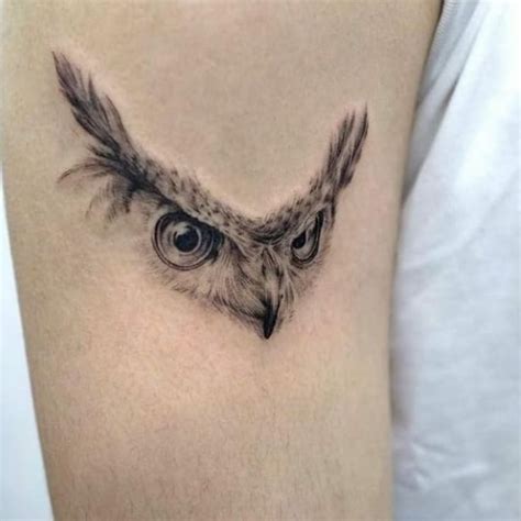 An Owl S Eye Tattoo On The Right Arm And Shoulder Is Shown In Black Ink