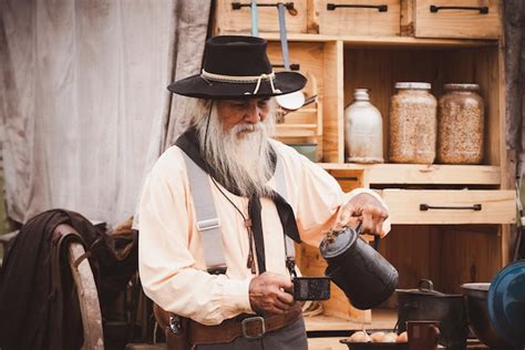 Premium Photo | Cowboy posing shooting rifle by gun on hand to show ...