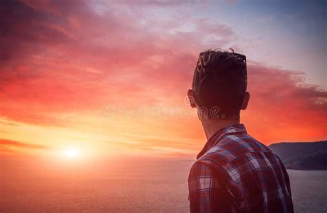 Silhouette Of A Man Watching The Sunset On The Beach Stock Image