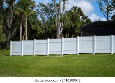 white vinyl picket fence  green stock photo  shutterstock