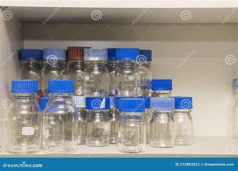 A Group Of Glass Laboratory Bottles With Bleu Caps On A Shelve Stock Image Image Of Bleu