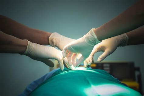 Premium Photo Cropped Hand Of Doctor Examining Patient