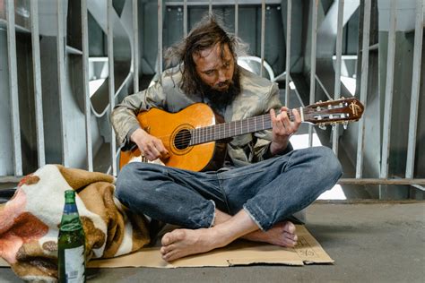 A Homeless Man Playing an Acoustic Guitar · Free Stock Photo