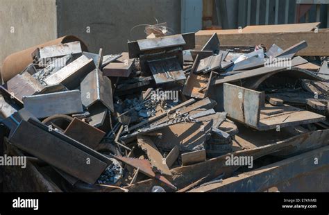 A Skip Full Of Rusting Scrap Steel And Other Metal Sits Waiting For