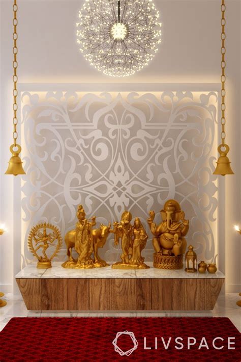 A Room With Some Gold Statues On The Wall And Lights Hanging From It S