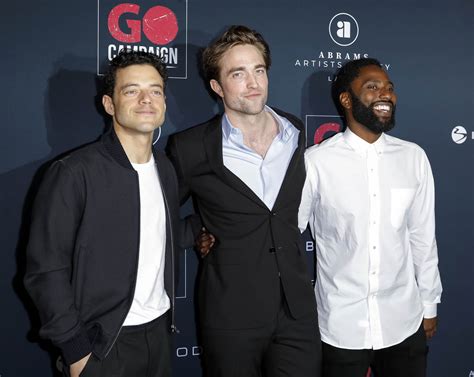 Robert Pattinson supported by friends John David Washington and Rami Malek at the GO Gala