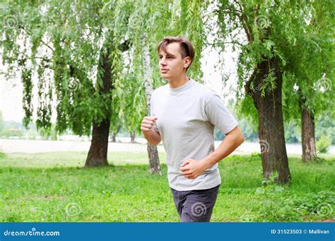 Young Man Running In The Park Stock Image Image Of Activity Forest