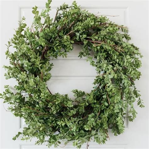 A Green Wreath Hanging On The Front Door