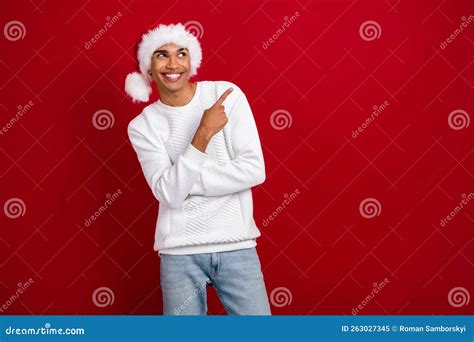 Photo Of Young Smiling Positive Man Wear Santa Claus Headwear Finger Direct Empty Space Look