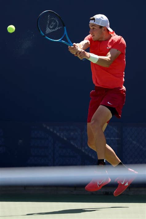 a man hitting a tennis ball with a racquet