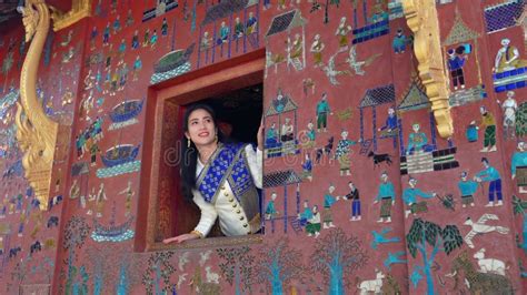 Asian Woman Wearing A Lao National Costume Visits Wat Xieng Thong One