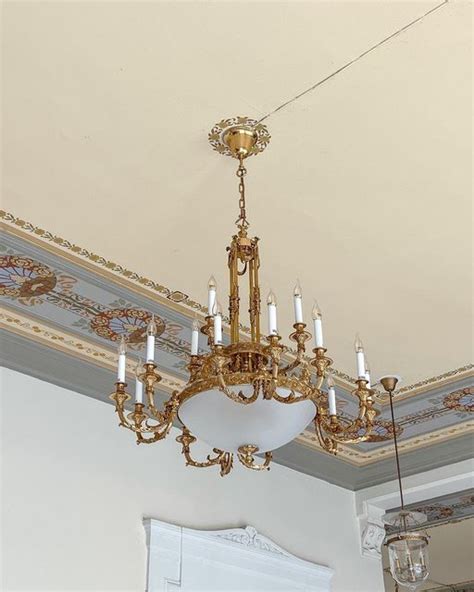 A Chandelier Hanging From The Ceiling In A Room With White Walls And