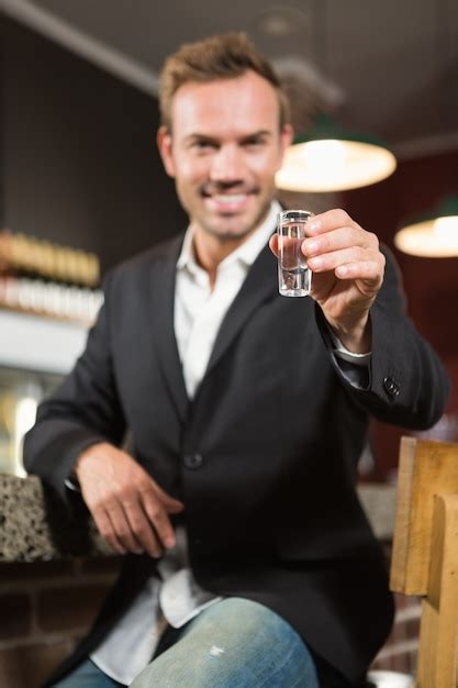 Premium Photo | Handsome man having a shot of alcohol