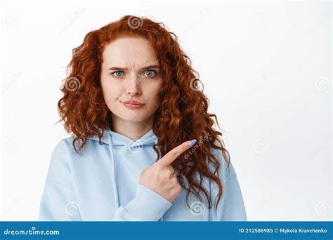 Disappointed Frowning Redhead Woman Pointing Finger Right At Something Bad Scolding Or