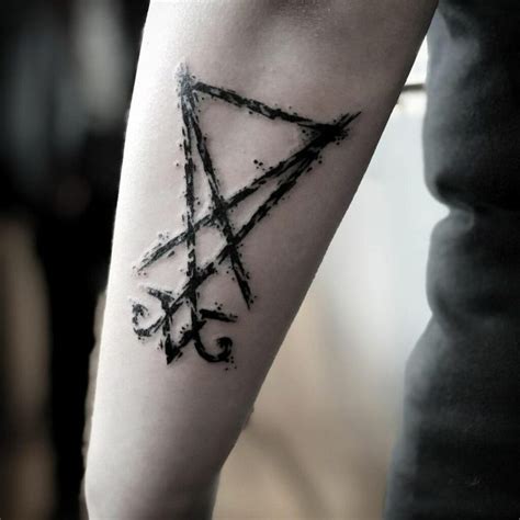 A Person With A Tattoo On Their Arm Has A Pentagramil In The Shape Of A