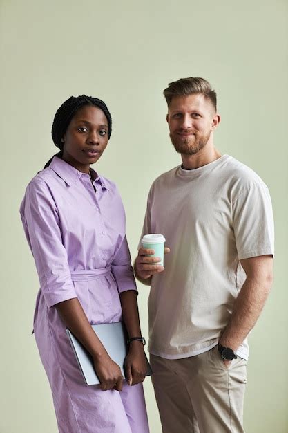 Premium Photo Minimal Portrait Of Two Young Business People Man And Woman Looking At Camera