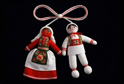 Premium Photo | Two martenitsa dolls in traditional clothing are ...