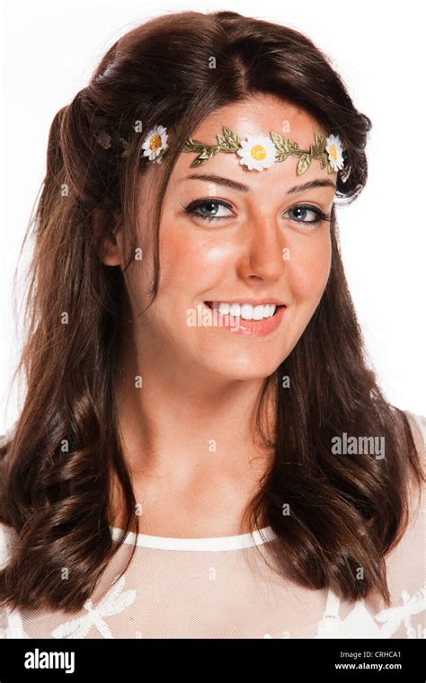An Eighteen Year Old Brunette Woman In A White Sun Dress With A Flowered Headband In Studio Over